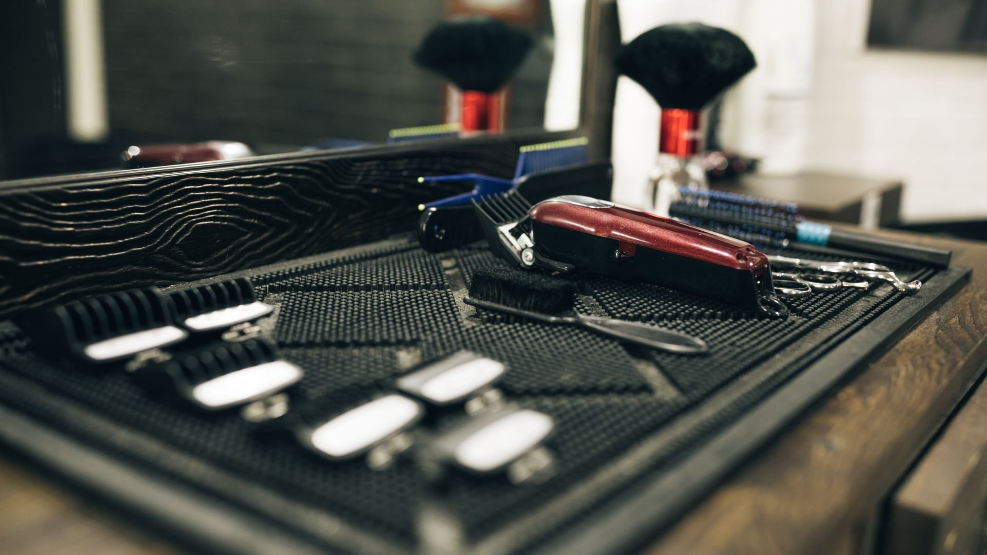 Professional barber tools including clippers and scissors displayed on salon counter